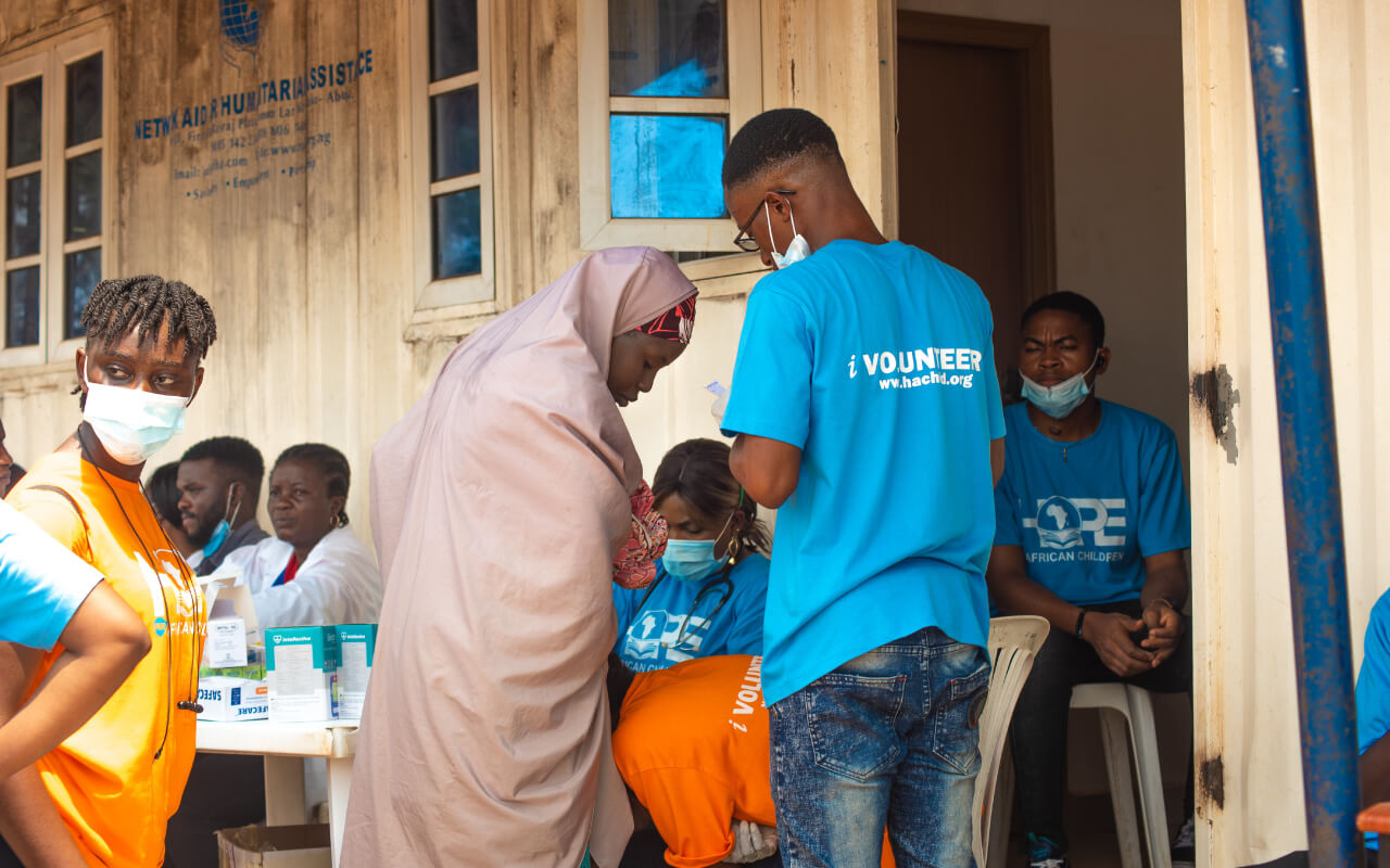 HOPE-Volunteer-assisting-a-female-during-a-medical-camp