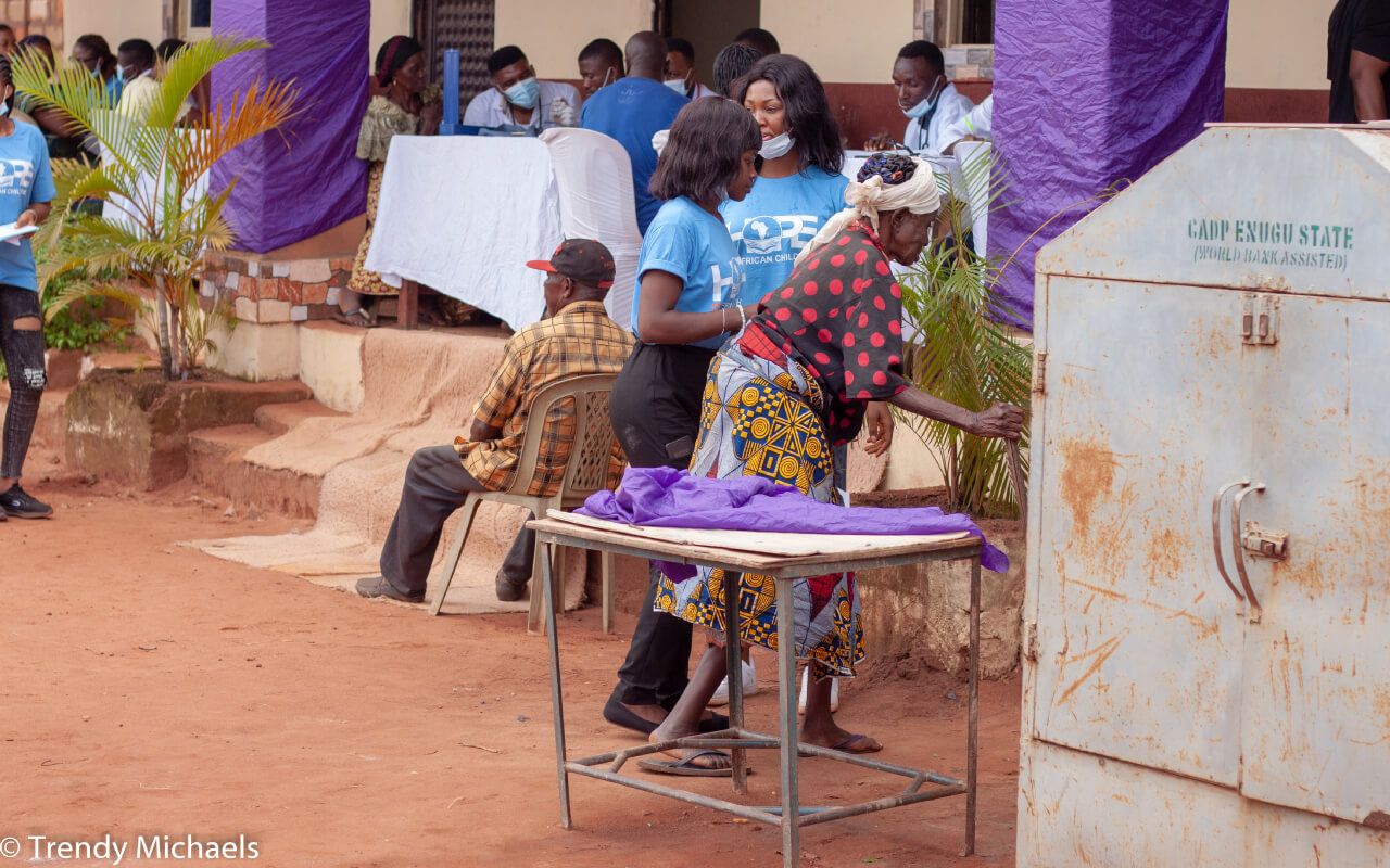 HOPE-Volunteer-assisting-an-old-lady-during-a-medical-camp